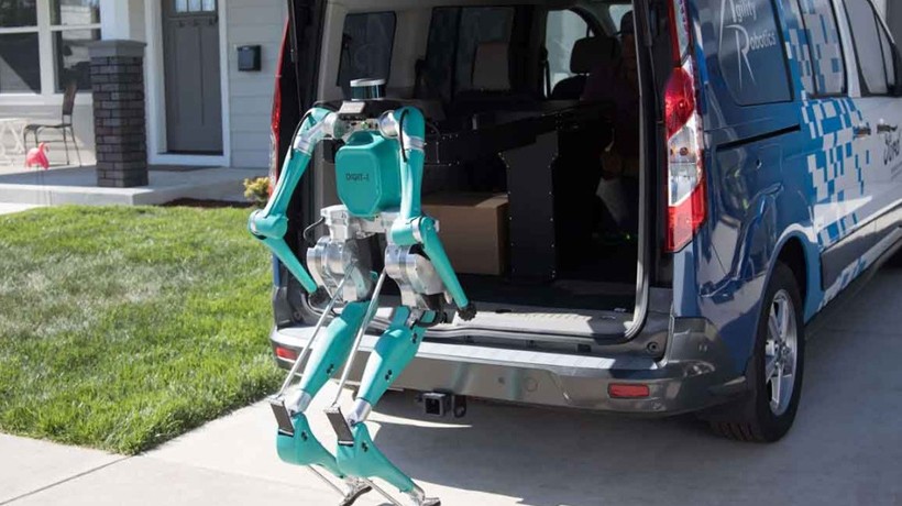 Robot Digit standing by open hatchback on van