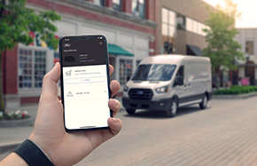 hand holding smartphone looking at delivery van